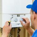 man installing or servicing a central heating boiler 
